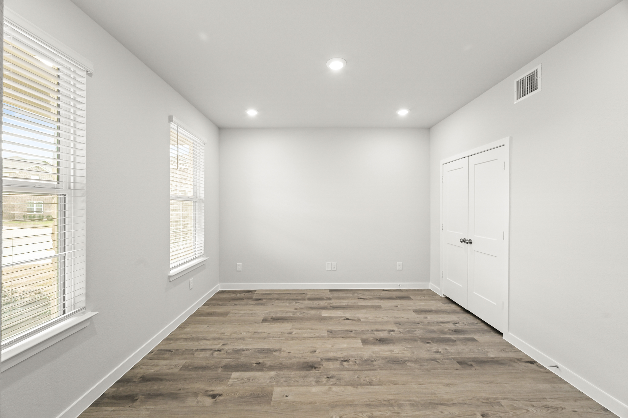 A room with white walls and windows.