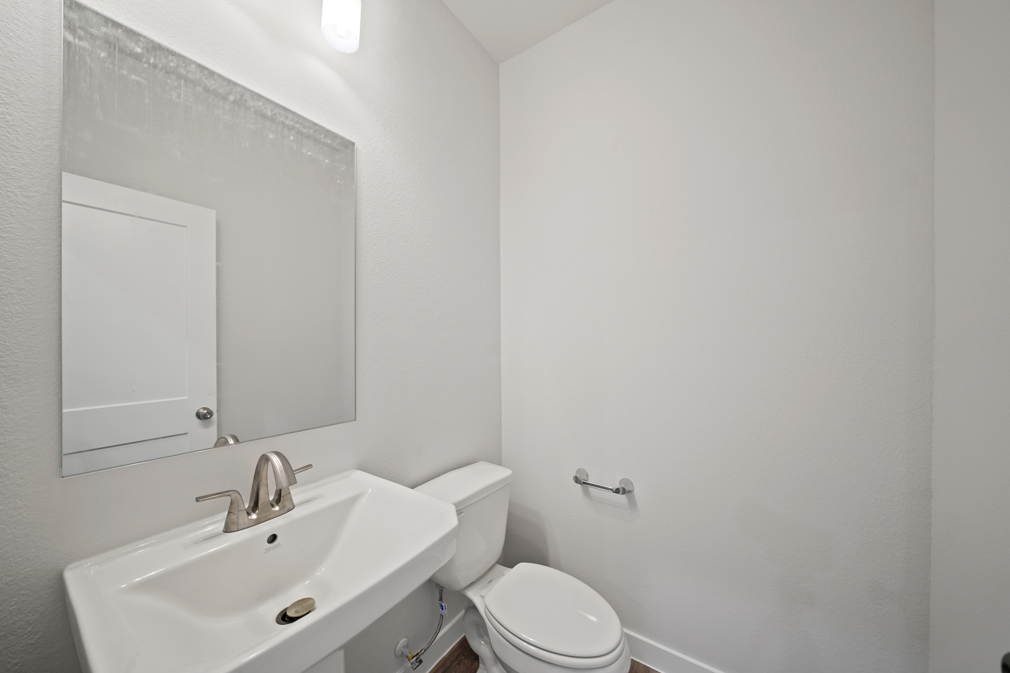 A bathroom with a toilet and sink.