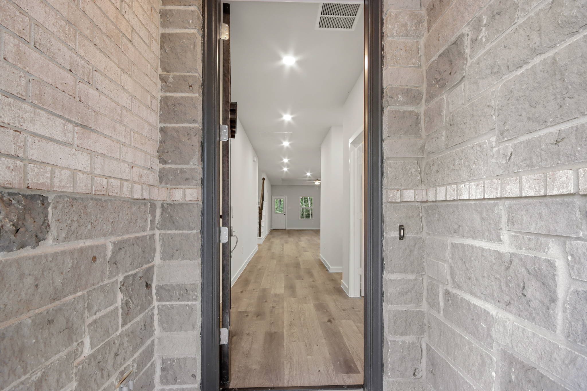 A hallway with brick walls.