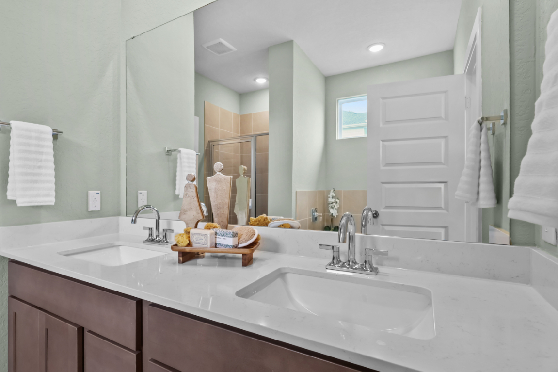 A bathroom with a large mirror.