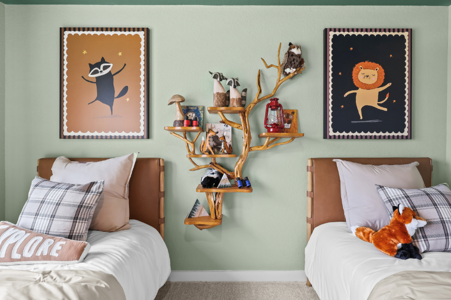 A bedroom with a bed and a shelf with art on it.
