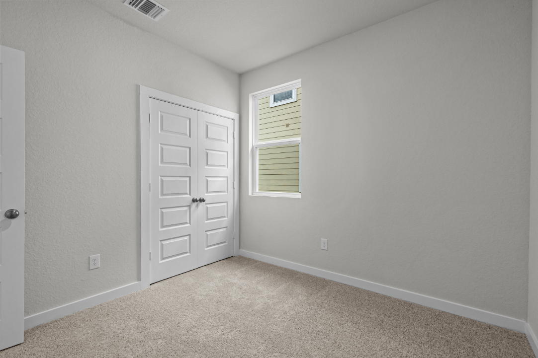 A room with white walls and a door.