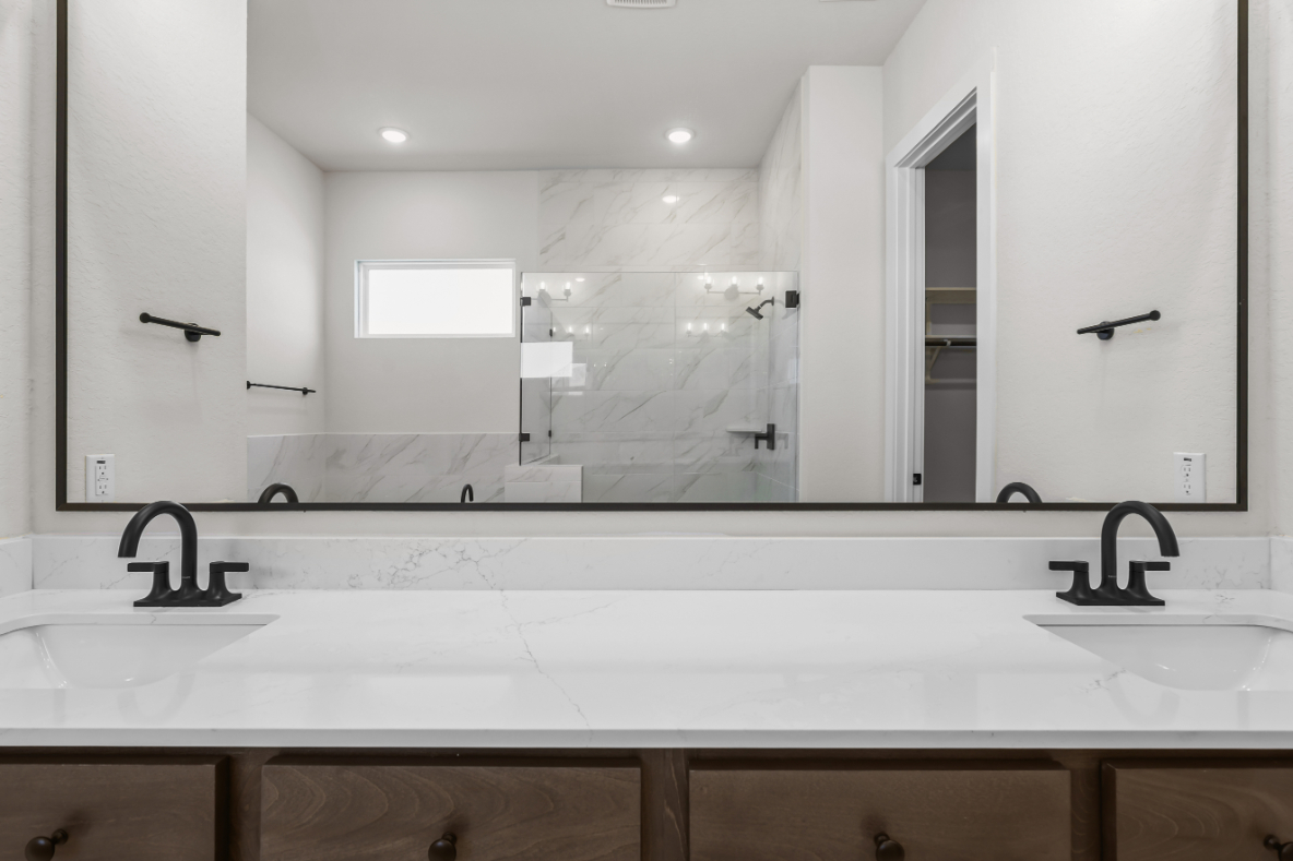 A bathroom with a large mirror.