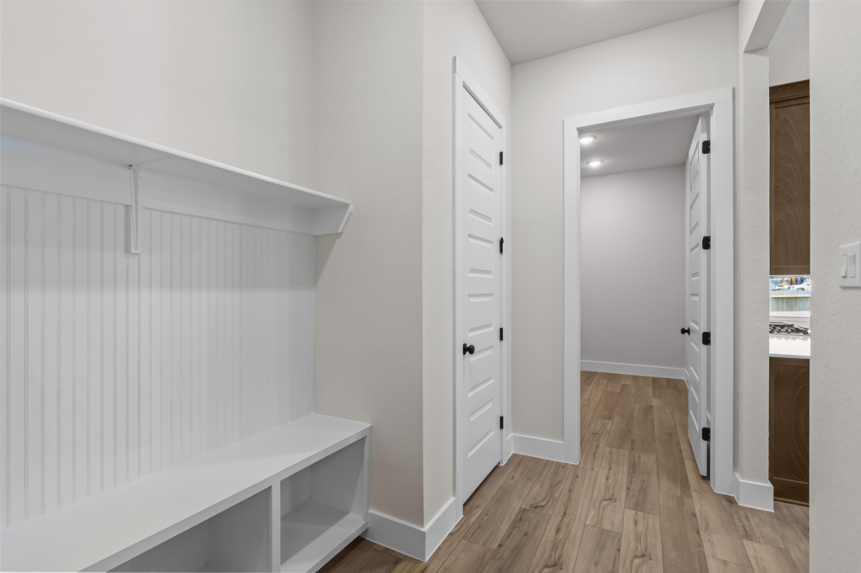 A white room with a wood floor.