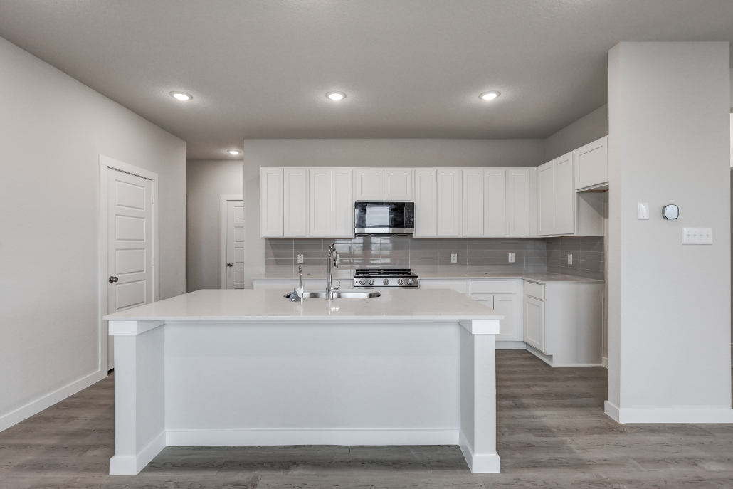 A kitchen with white cabinets.