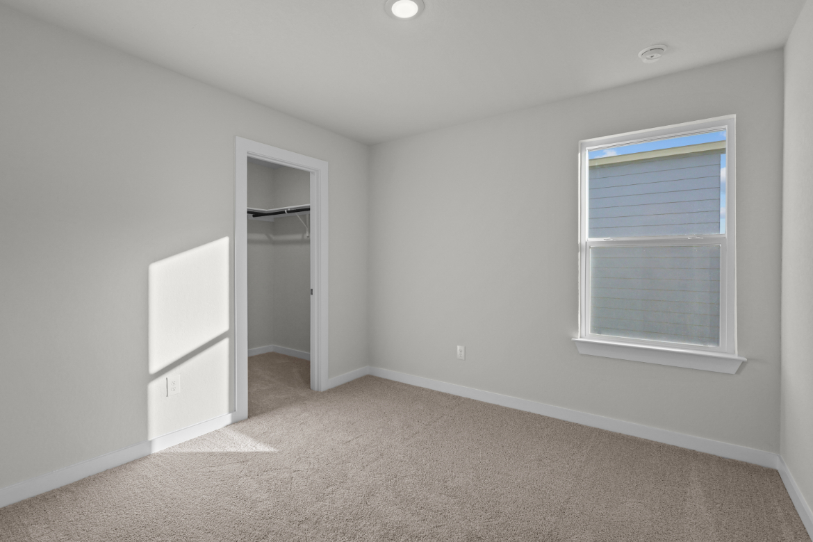 A room with a window and a door.