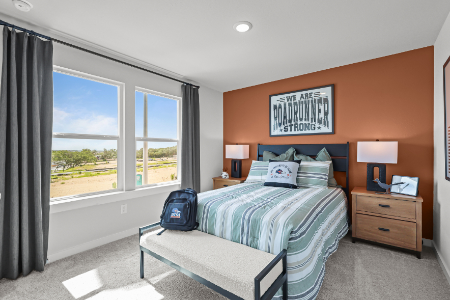 A bedroom with a large window.