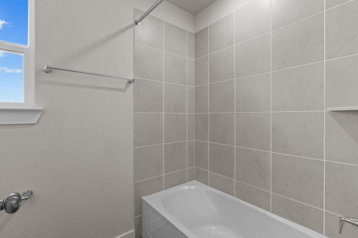 A bathtub and a shower unit.