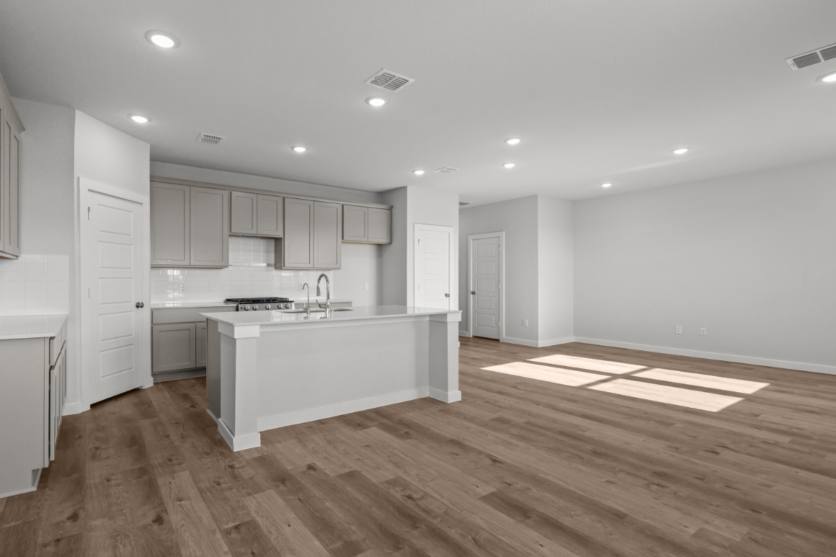 A kitchen with white cabinets.