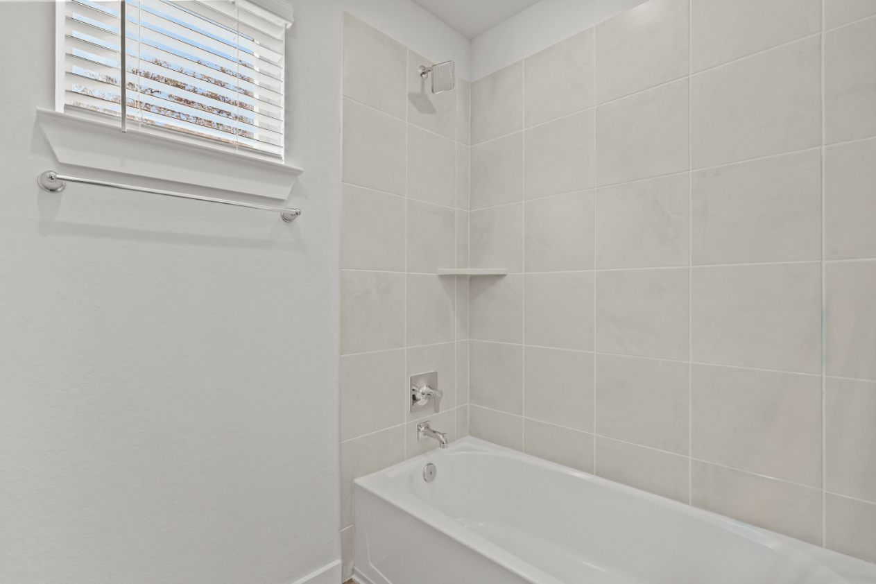 A bathtub in a bathroom.