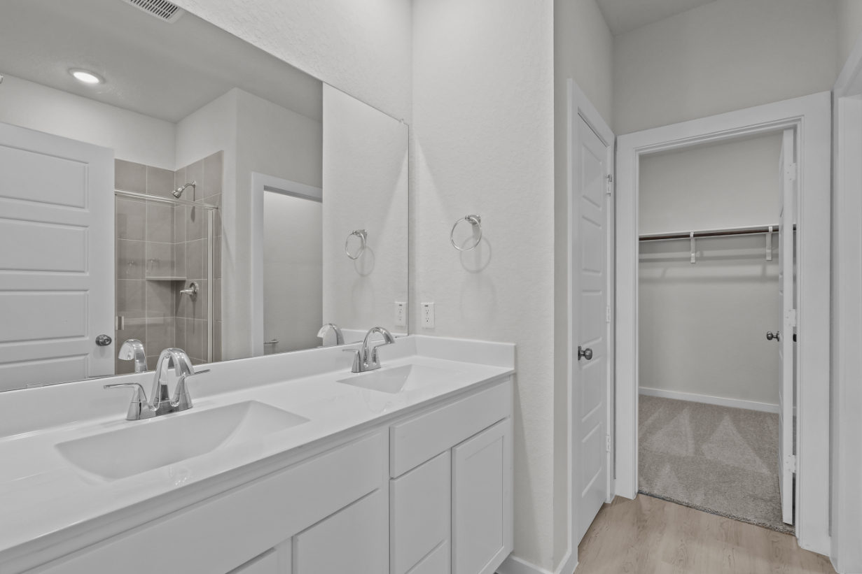 A bathroom with a sink and a shower.