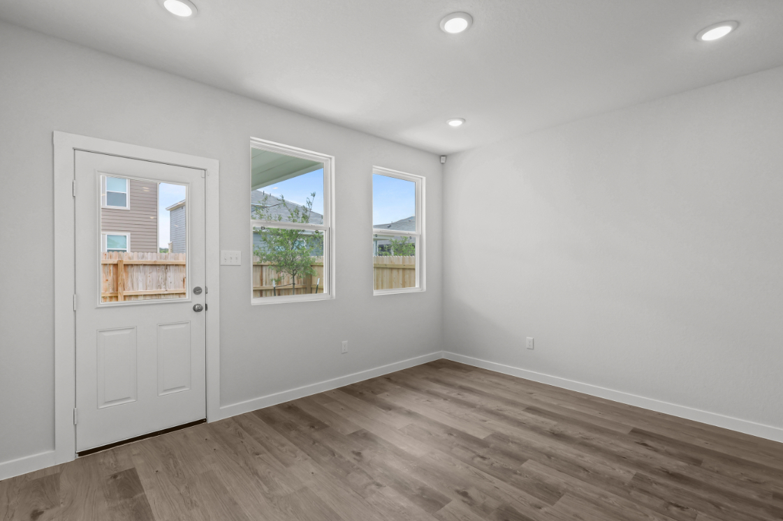 A room with white walls and windows.