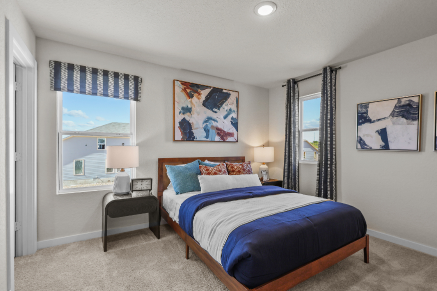 A bedroom with a bed and a desk.