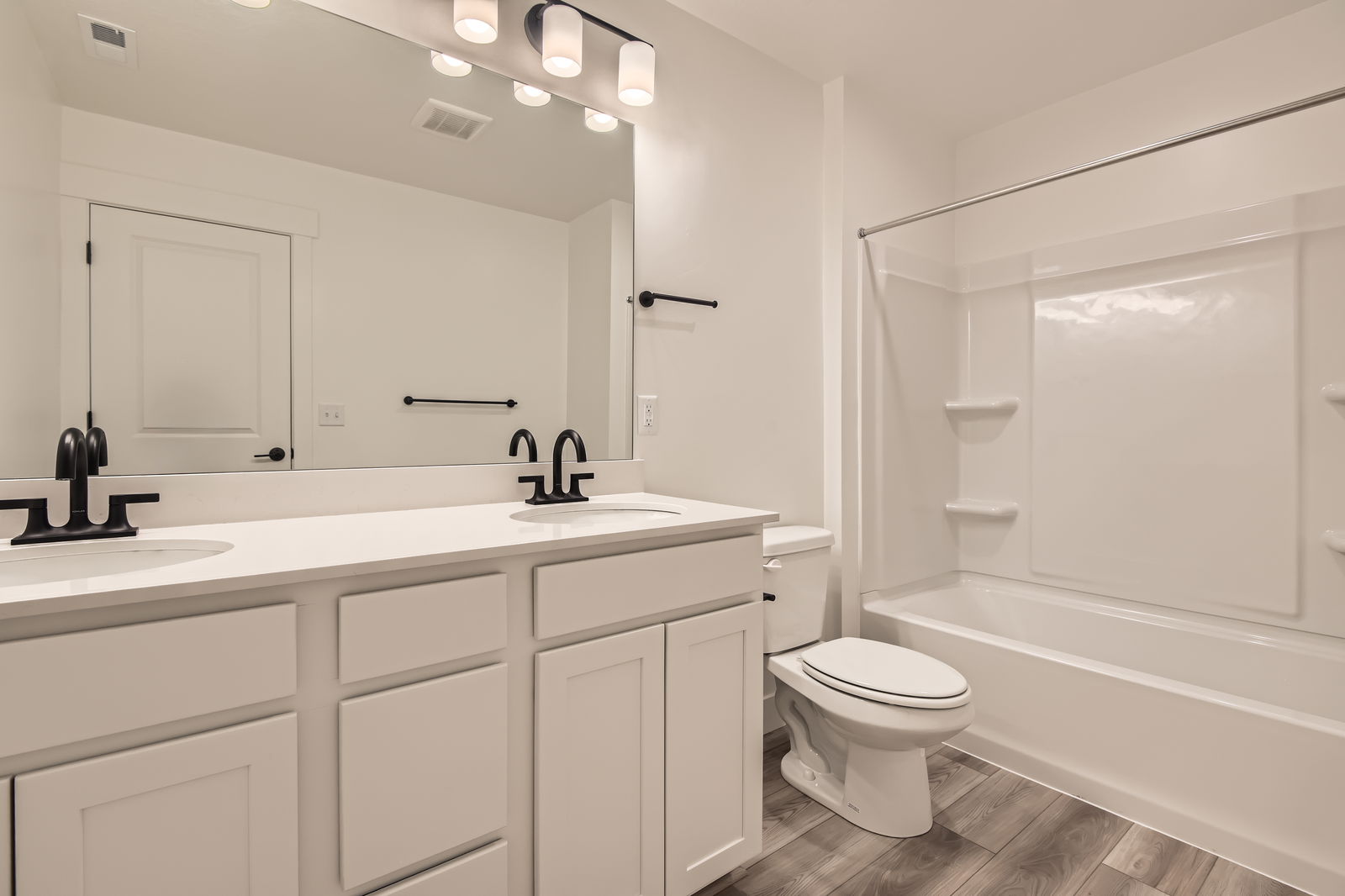 A bathroom with a tub toilet and sink.