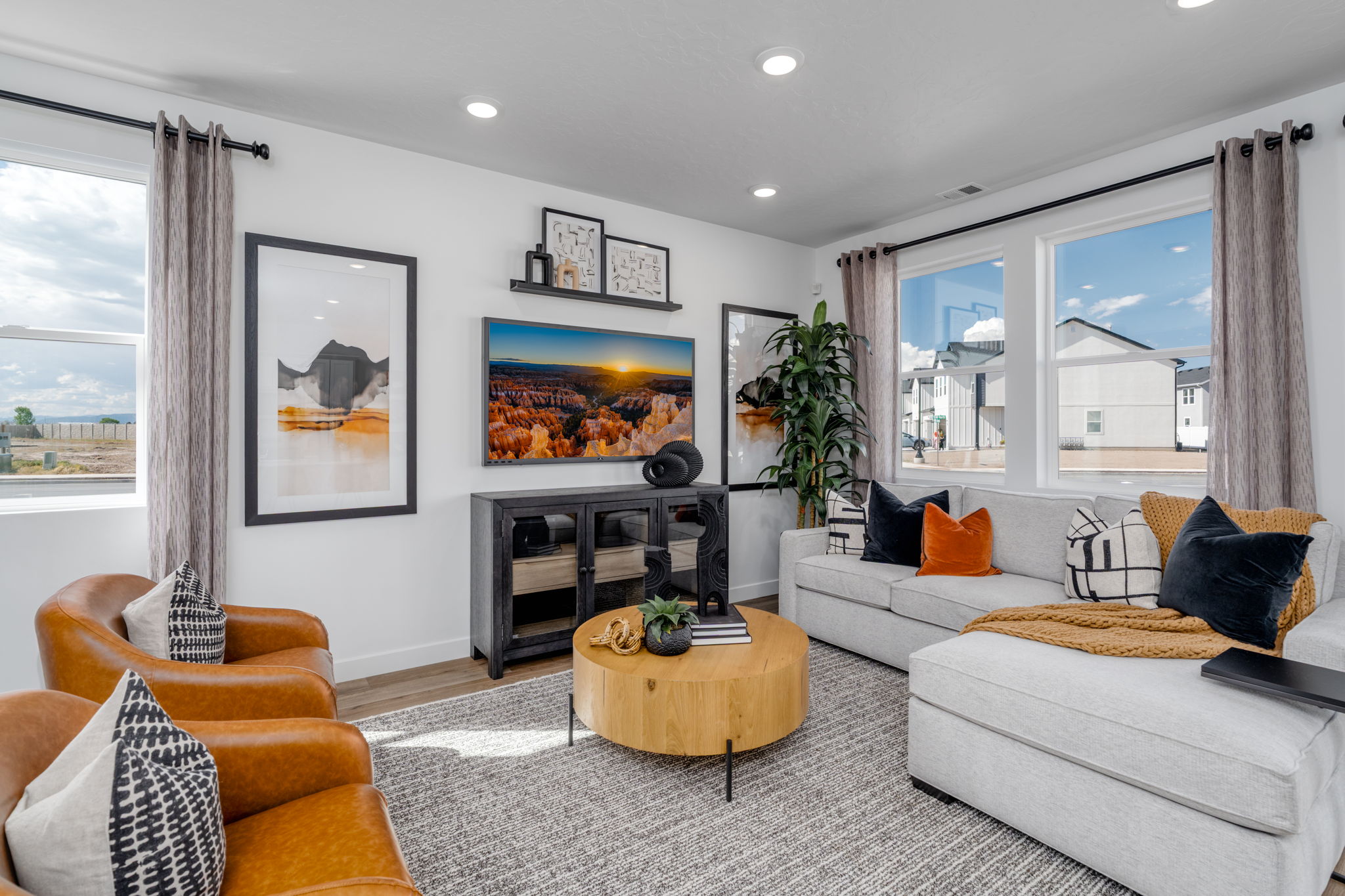 A living room with a fireplace and a large window.