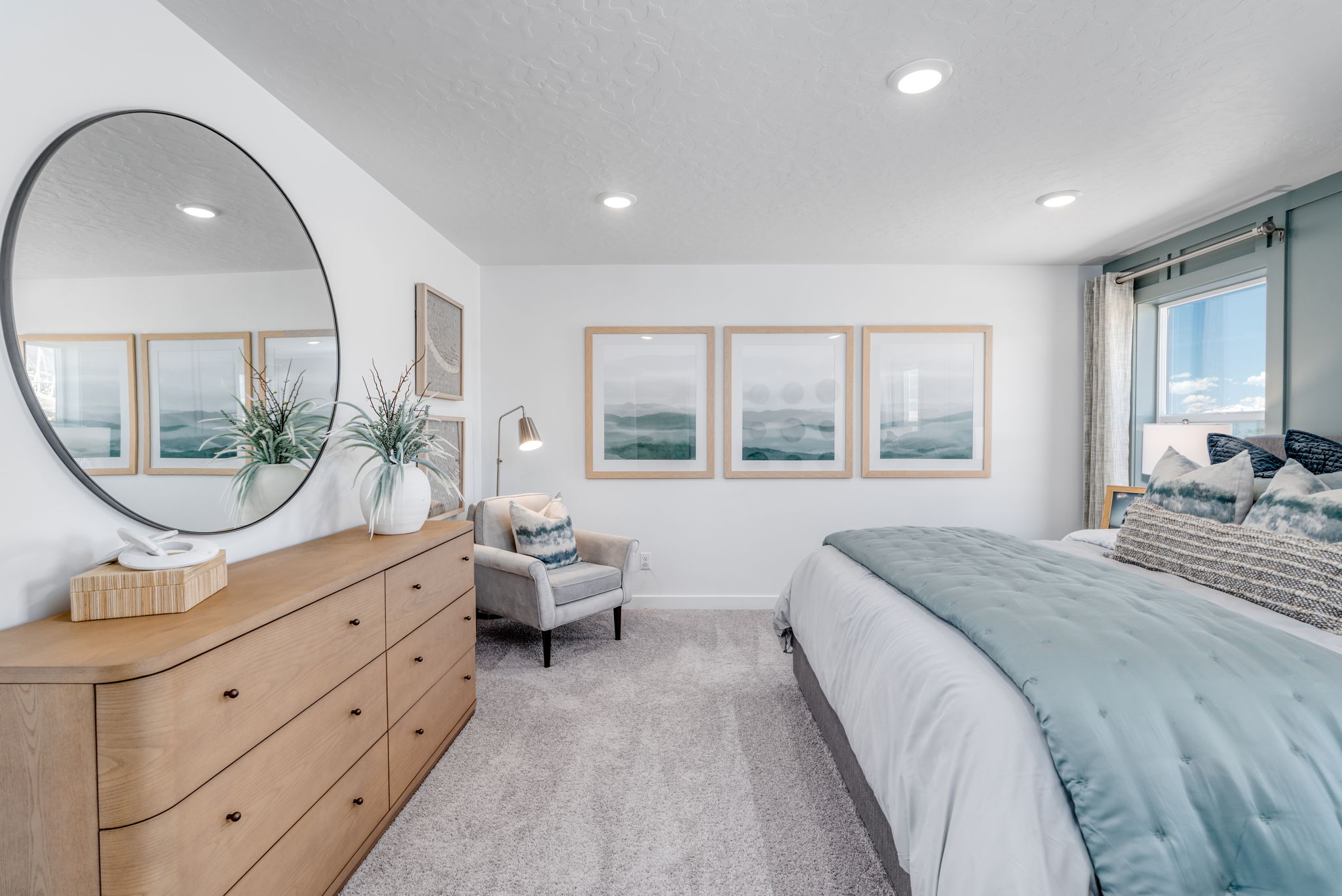 A bedroom with a large mirror.