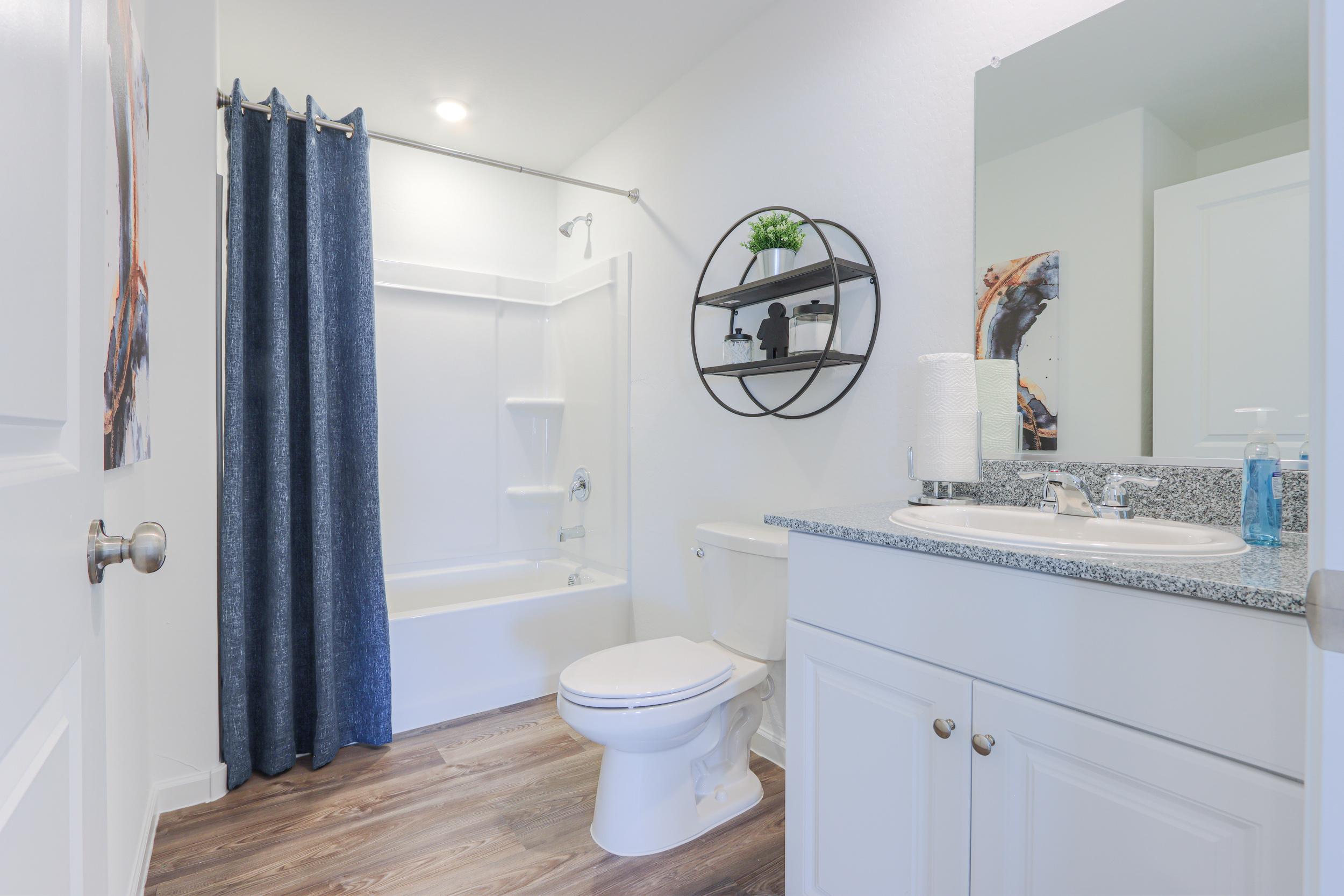 A bathroom with a tub toilet and sink.