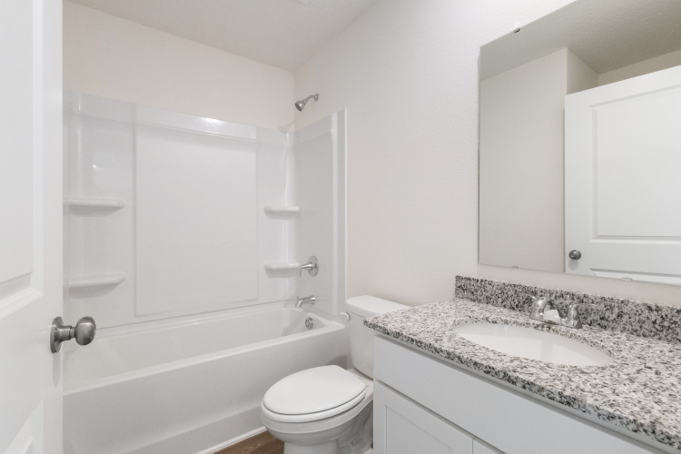 A bathroom with a marble countertop.