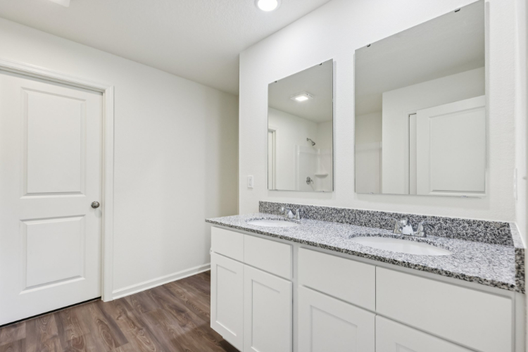 A kitchen with white cabinets.