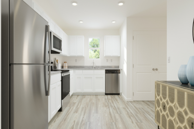 A kitchen with white cabinets.