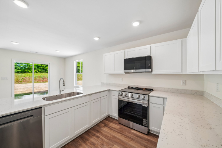 A kitchen with white cabinets.