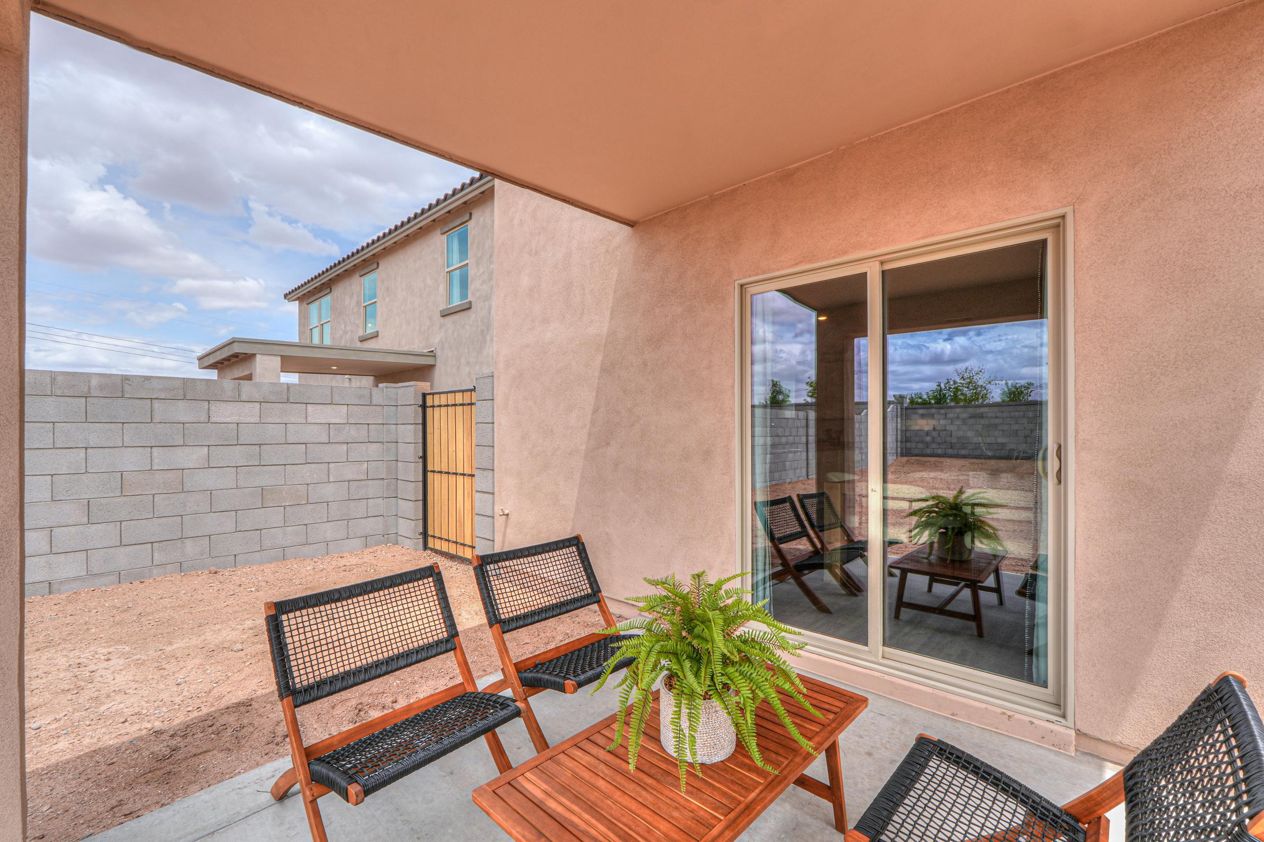 A patio with chairs and a table.