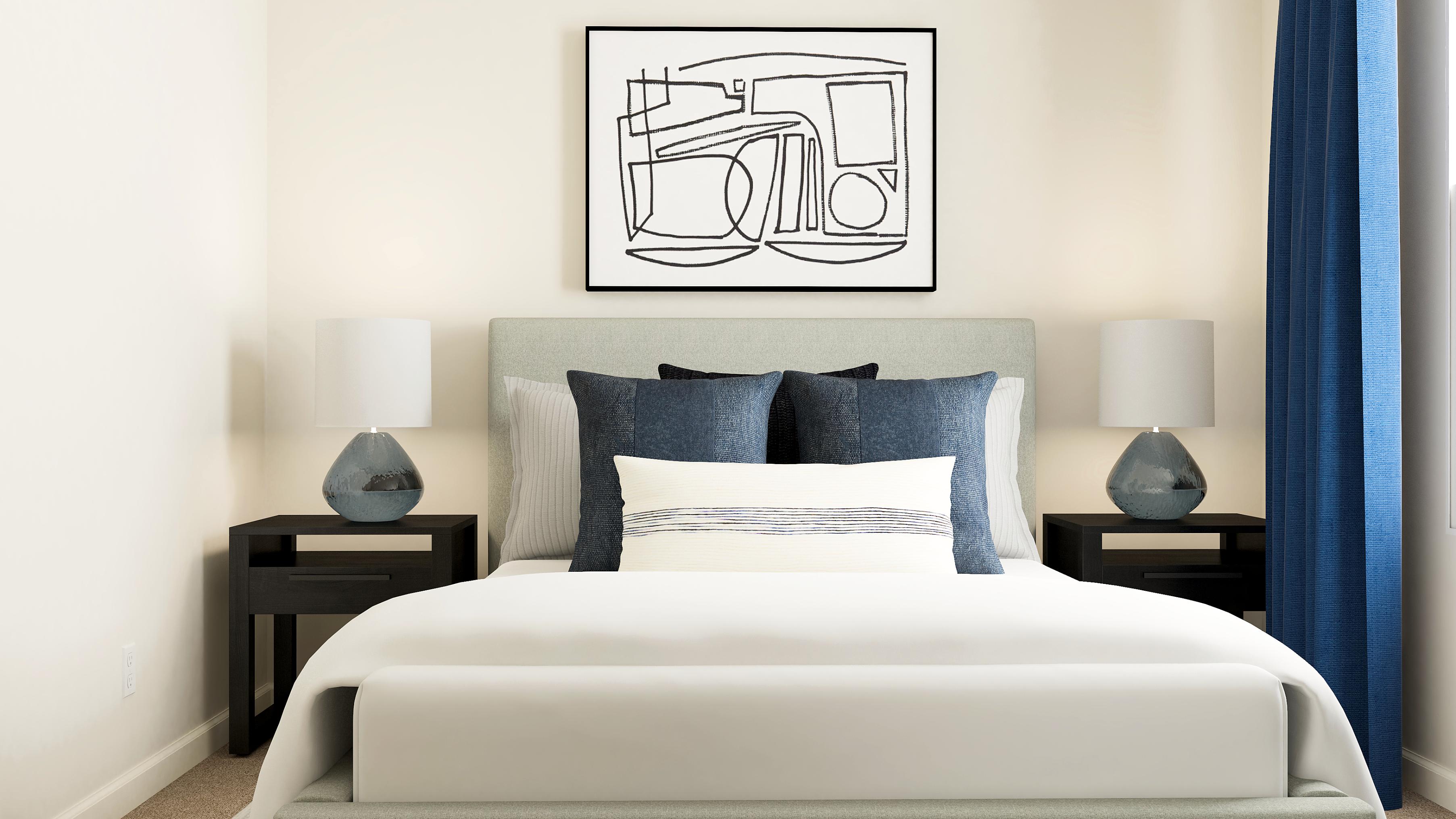 A bed with a white bed spread.