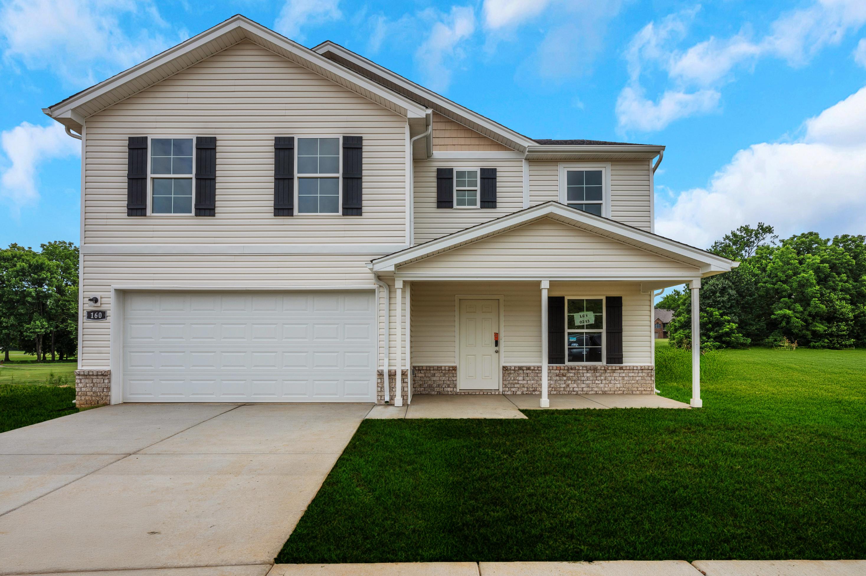 A white house with a lawn.
