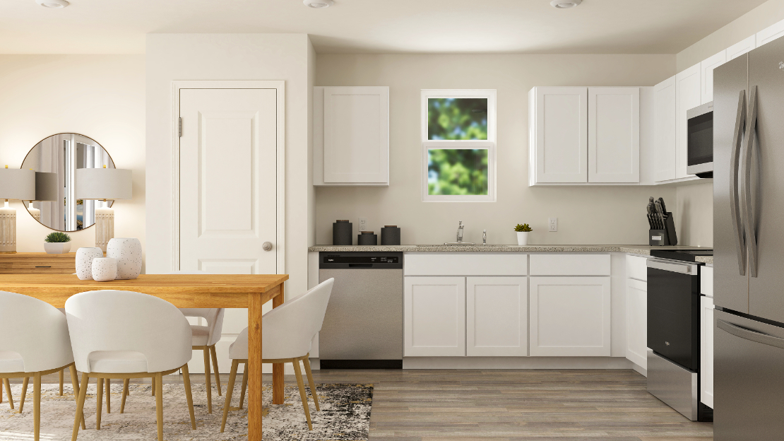 A kitchen with white cabinets.